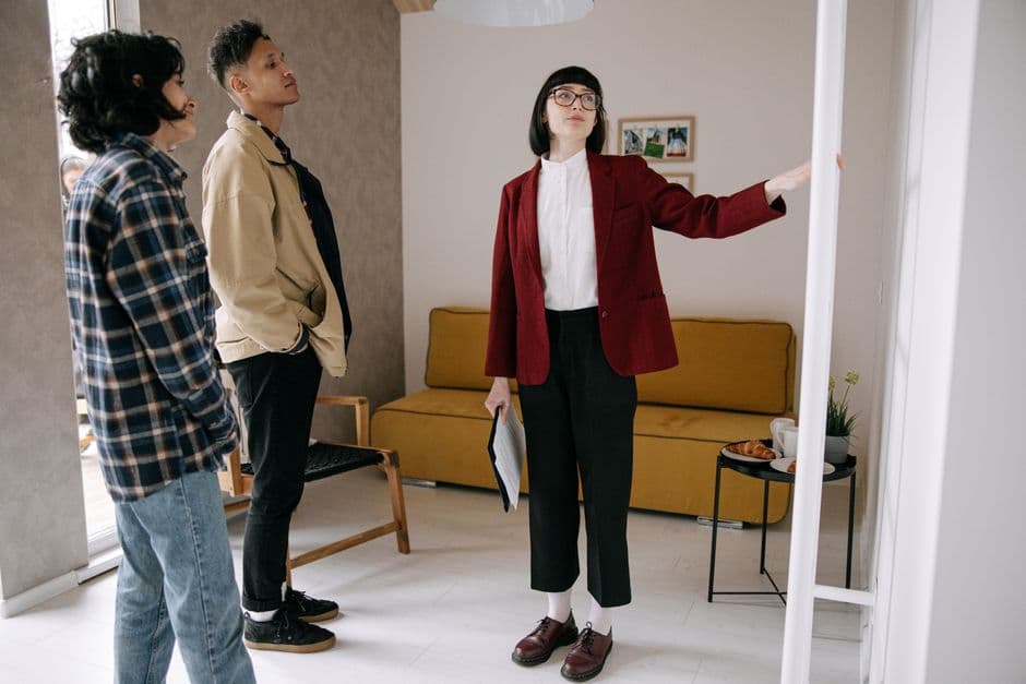 Agent showing a home to a young couple